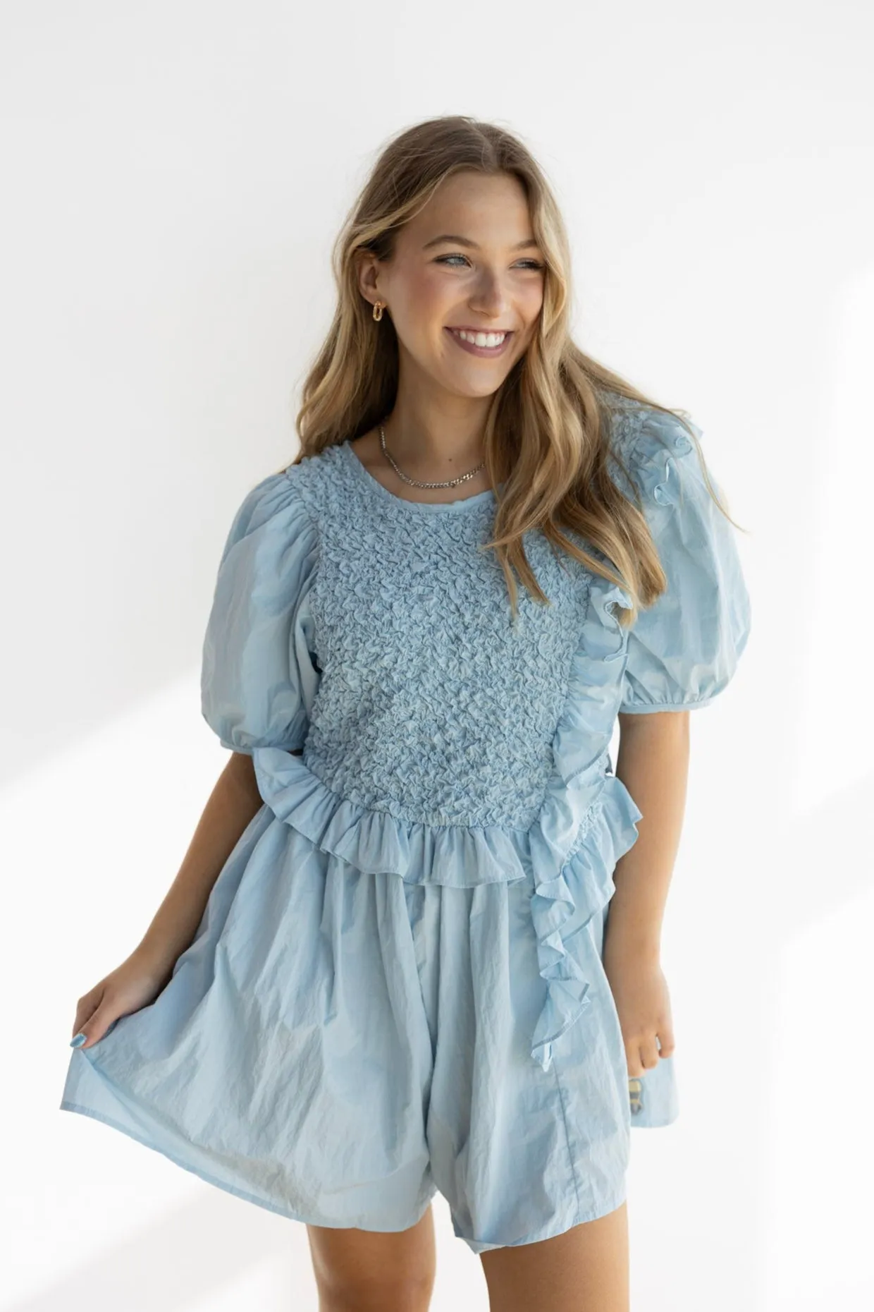 NOA RUFFLE SMOCKED ROMPER